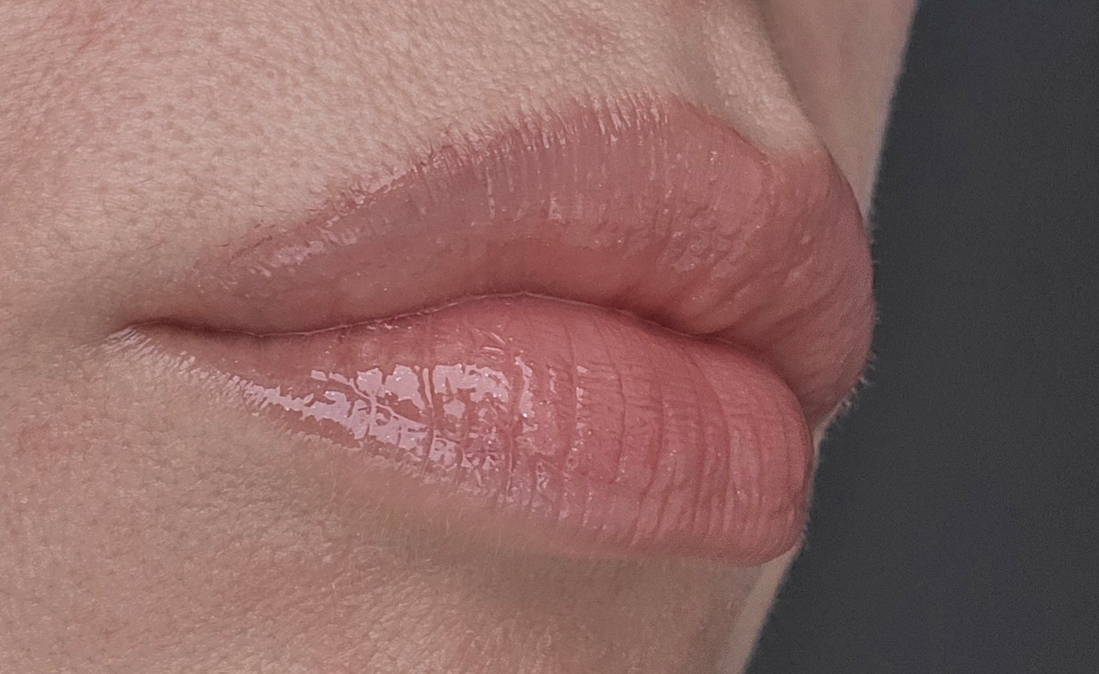 На губы нанесен контурный карантдаш и блеск