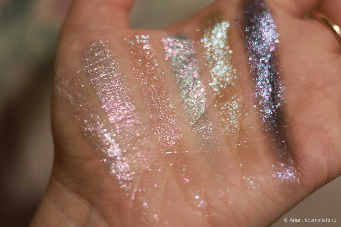 Свотчи сверкающих оттенков в расфокусе под электрическим светом (слева направо): Arctic Wolf - Alpha Moon - Majestic Moon - Winter Howl - Moonlight Prowl - Nightfall